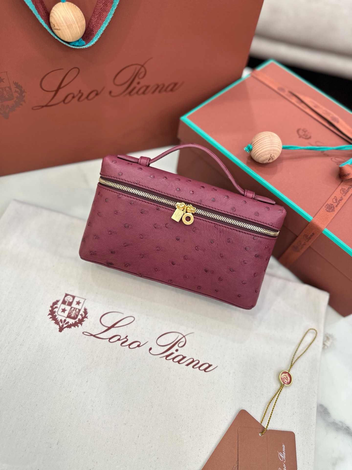 Burgundy ostrich leather Loro Piana L19 handbag with gold hardware