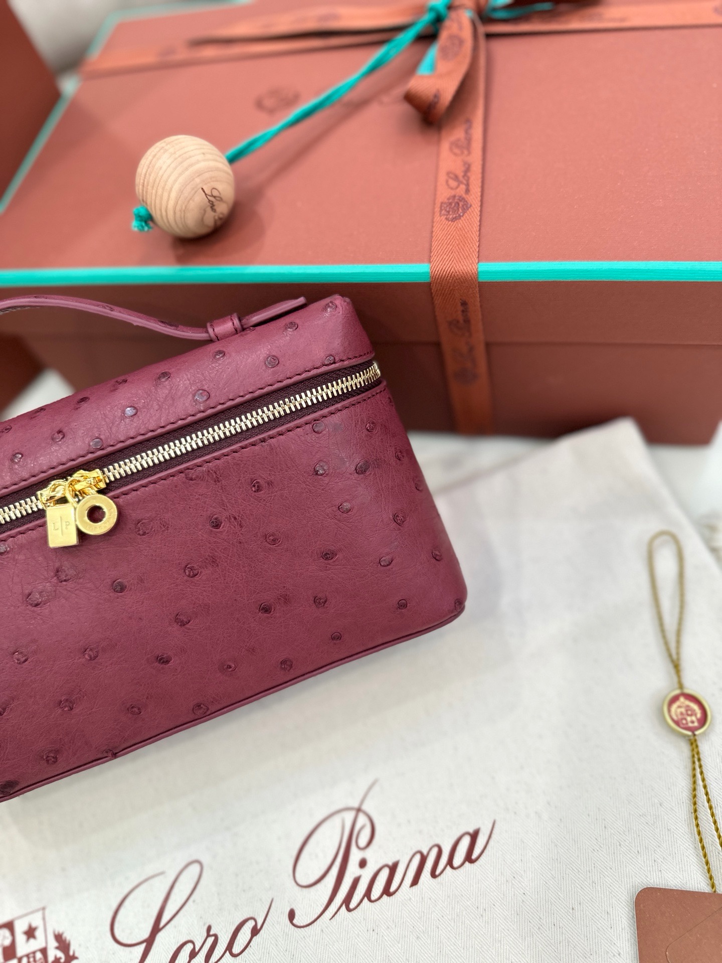 Burgundy ostrich leather Loro Piana L19 handbag with gold hardware