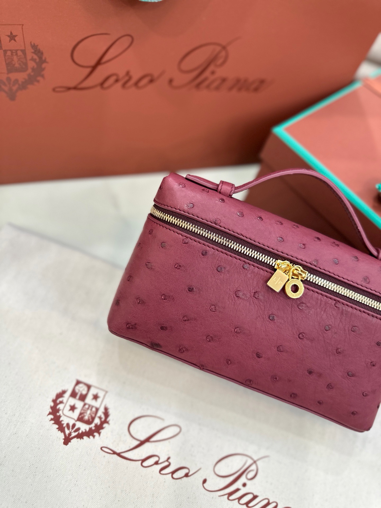 Burgundy ostrich leather Loro Piana L19 handbag with gold hardware